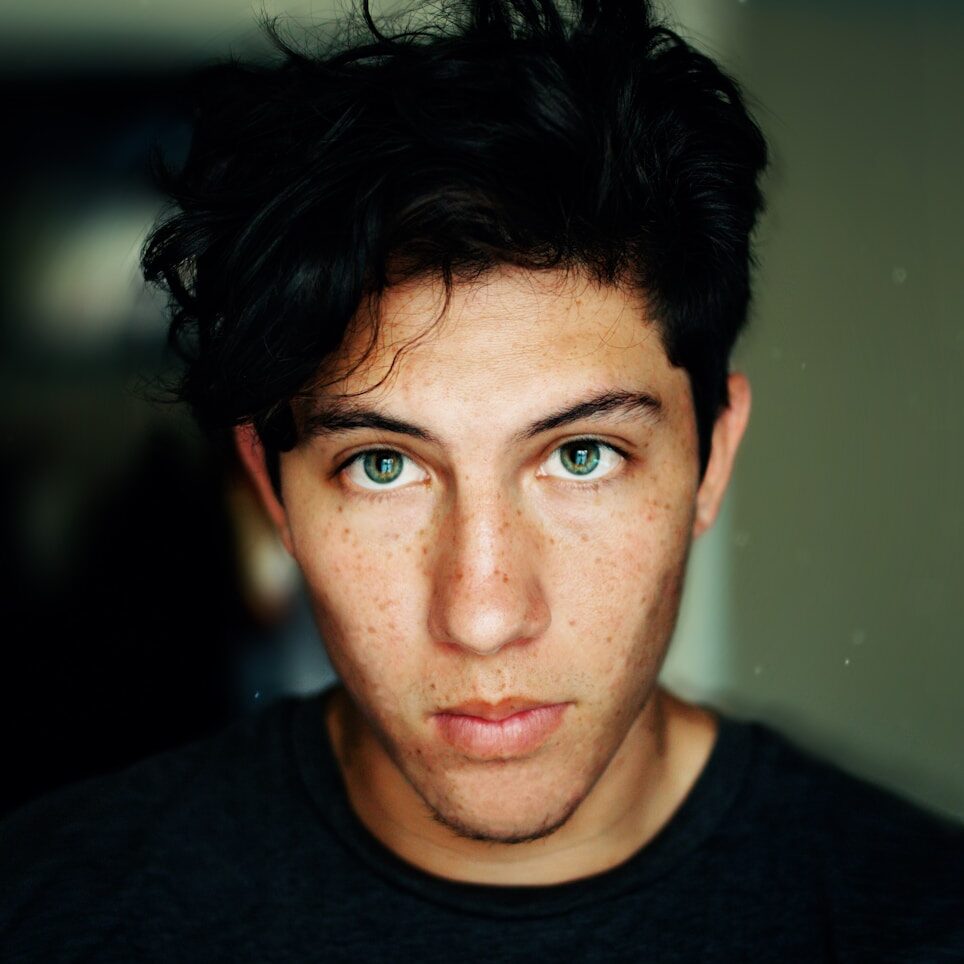 man wearing black crew-neck shirt